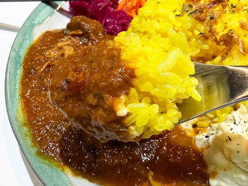A close-up of a spoonful of curry